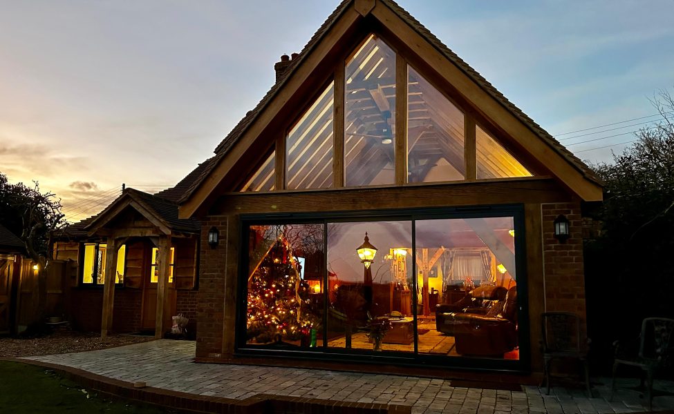 Large wrap around extension with open vaulted oak frame living space.